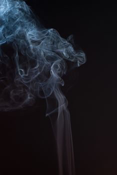 Beautiful smoke on the black background - macro photo.