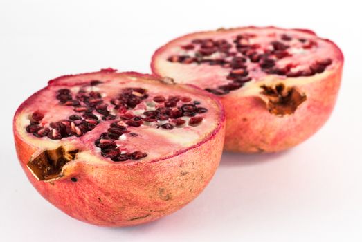 two halfs ripe pomegranate fruit isolated on white background. cutout