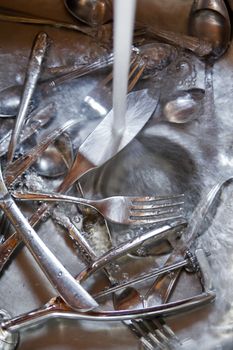 Sink with cutlery ready to be washed