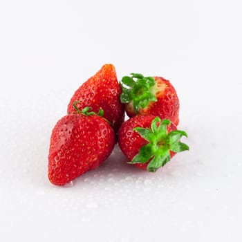 Closeup of strawberry with dew drops on white background