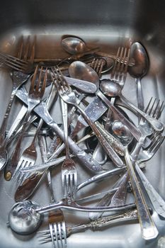 Sink with cutlery ready to be washed