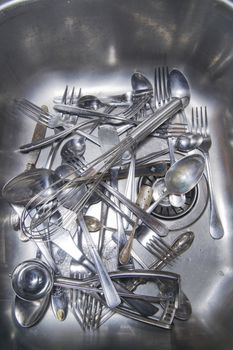 Sink with cutlery ready to be washed