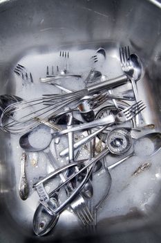 Sink with cutlery ready to be washed