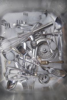 Sink with cutlery ready to be washed