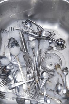 Sink with cutlery ready to be washed