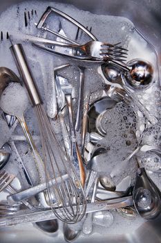 Sink with cutlery ready to be washed