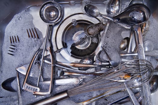 Sink with cutlery ready to be washed