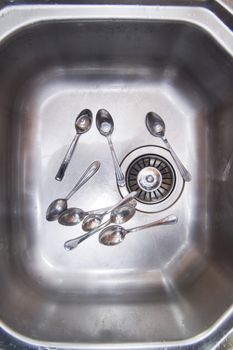 Sink with cutlery ready to be washed