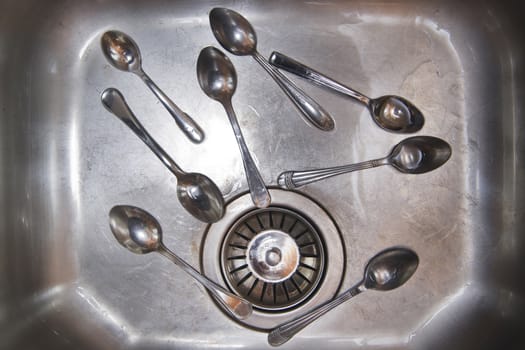 Sink with cutlery ready to be washed