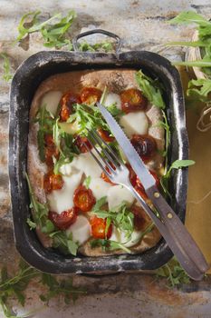 Tricolor pizza with tomato mozzarella and fresh arugula 