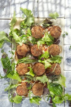 Second dish of meatballs and green salad