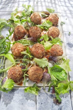 Second dish of meatballs and green salad