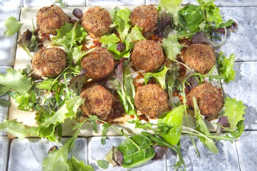 Second dish of meatballs and green salad