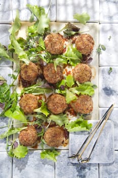 Second dish of meatballs and green salad
