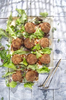 Second dish of meatballs and green salad