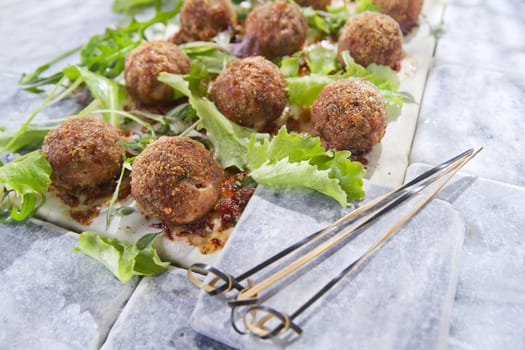 Second dish of meatballs and green salad