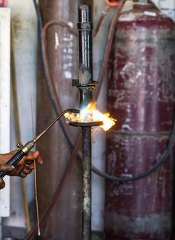 Welders were repairing cutting Shock absorbers of a car