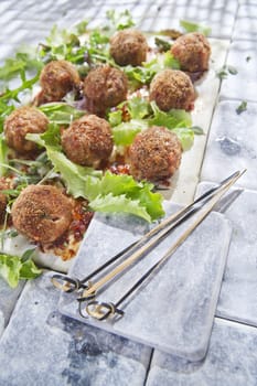 Second dish of meatballs and green salad