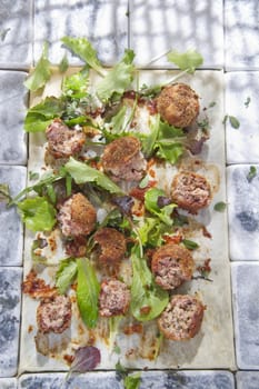 Second dish of meatballs and green salad