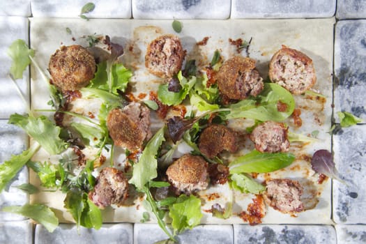 Second dish of meatballs and green salad