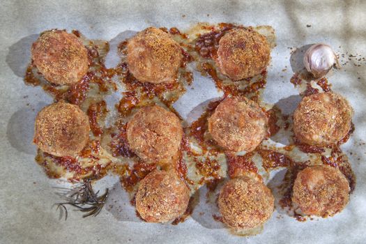 According plate of meatballs and baked potatoes