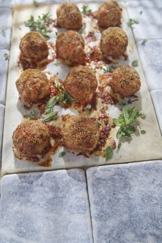According plate of meatballs and baked potatoes