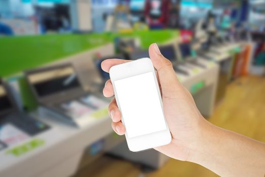 Hand holding smart phone with blur background of shopping IT mall market