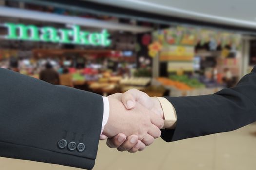 Business handshake with blur background of shopping mall market