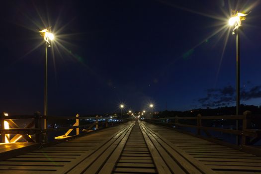 Utamanusorn Bridge (Mon Bridge), made from wooden for across the river at night, Sangkhlaburi District, Kanchanaburi Thailand at night