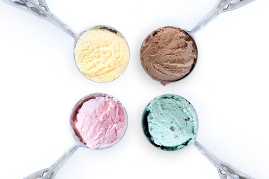 Close up of four flavored ice cream scoops over a white background