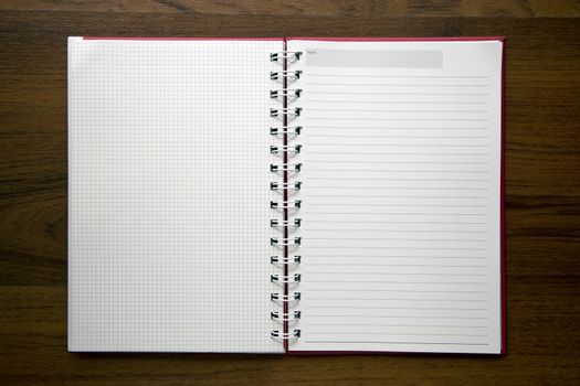 Blank notebook paper on wooden desk background