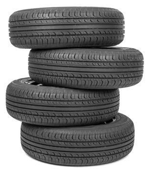 Stack of four wheel black tyres for summer isolated on white background