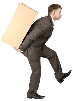 Young man in suit hold box on back. Isolated