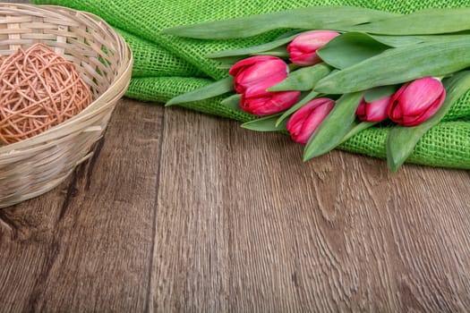 Red tulip on a brown wooden background
