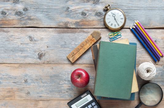 School stationery accessories on a wooden table with space for text 