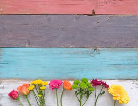 Assorted flower border over a wooden background