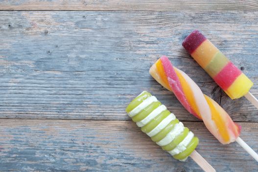 Frozen ice lollies on a wooden background