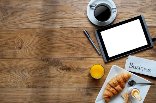 Breakfast with digital tablet on a wooden background with space 