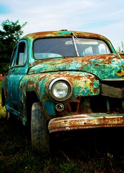 Grunge Old Pimped Rusty Car on Blue Sky background Outdoors