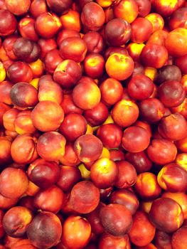 Sweet red peaches at the market. Fruit background.