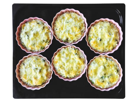 Baking tray with freshly baked cheese and broccoli pies. Isolated on white.