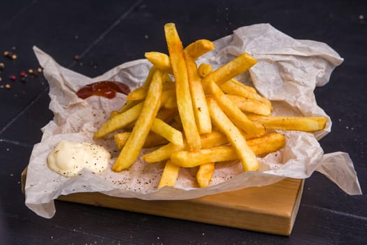 Homemade fries on a table with ingredients and cutlery around. Concept: healthy food, diet, fastfood. 
