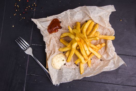 Homemade fries on a table with ingredients and cutlery around. Concept: healthy food, diet, fastfood. 