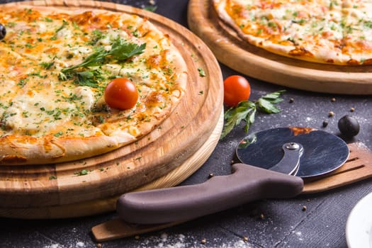 Concept: healthy food, diet. fast food. Fresh baked pizza on a wooden board with ingredients and cutlery around.