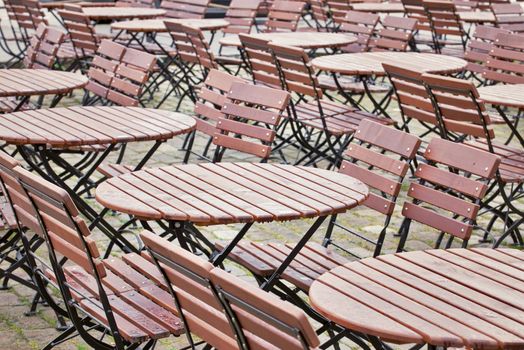 Brown tables and chairs outside a restaurant