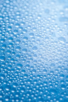 close-up of water drops on the blue background.