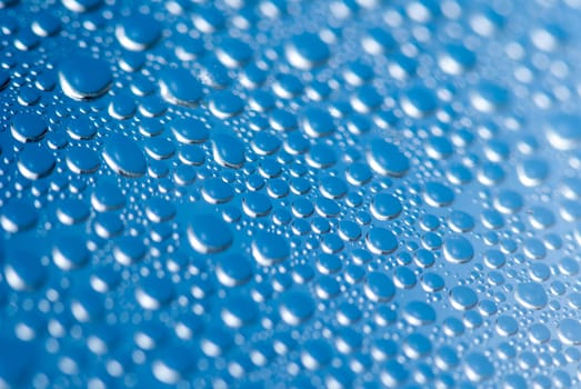 close-up of water drops on the blue background.