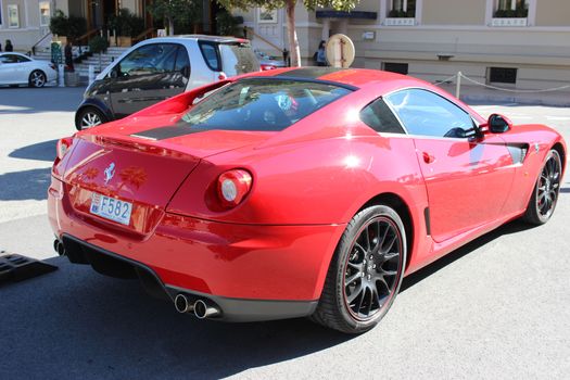 Monte-Carlo, Monaco - March 9, 2016: Red Ferrari 430 Scuderia (rear view) Parked in Front of the Monte-Carlo Casino in Monaco