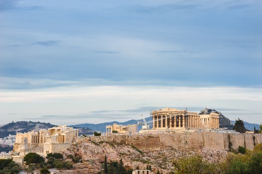 Ancient Acropolis in rays of sunset. Athens Greece. Copyspace.