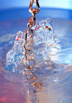 Water fantasy. Nice abstract color water surface with metal chain
